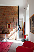 Open doorway next to brick wall in living room