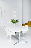 Designer furniture and wall decoration in white dining room