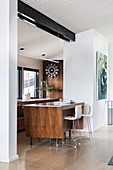 Elegant kitchen island with bar stools between the kitchen and living room