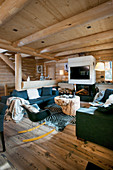 Modern furniture in cosy living room of log cabin