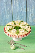 Egg salad with peas and mayonnaise, decorated like a pie