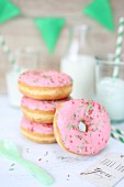 Pink doughnuts and glasses of milk