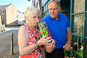 Woman with dementia smelling flowers