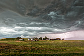 Storm over farmhouse, North Dakota, USA