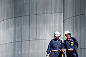 Engineers by oil storage tower