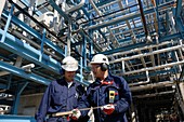 Oil refinery workers and pipework