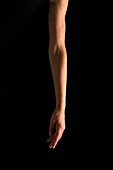 Arm against a black background