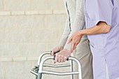 Senior woman using walking support frame