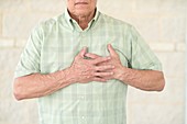 Senior man holding his chest in pain