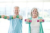 Senior couple using hand weights