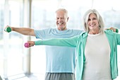 Senior couple using weights