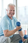 Senior man using weights