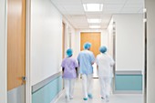 Medical staff walking down hospital corridor