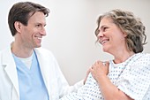 Doctor smiling at Woman patient