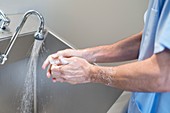 Doctor cleaning hands with soap and water