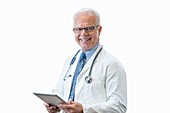 Senior male doctor with digital tablet