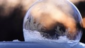 Ice crystals forming on a soap bubble