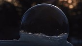 Ice crystals forming on a soap bubble