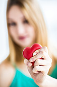 Woman kneading a stress ball heart shaped