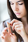 Woman putting a band-aid on her finger