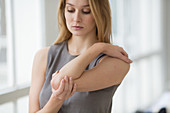 Woman suffering from pain in the elbow