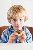 Boy eating chocolate on bread