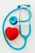 Stethoscope surrounding plastic heart