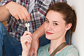 Young couple holding new house keys