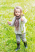 3-year-old girl holding a bouquet of wild flowers