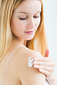 Skincare, Woman applying body cream