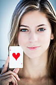 Female holding an ace of hearts