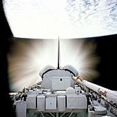 Space shuttle engines firing in orbit