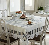 Toile de jouy tablecloth on dining table in traditional ambiance