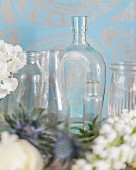 Arrangement of various glass vessels against blue-patterned background