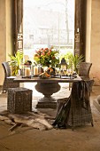 Solid stone table and wicker chairs in rustic country-house interior with historical ambiance