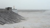 Waves crashing against lighthouse