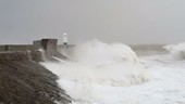 Waves crashing against lighthouse