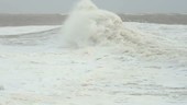 Waves crashing against lighthouse