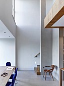 Dining area in high-ceiling room with gallery level