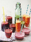 Various homemade smoothies in bottles and glasses