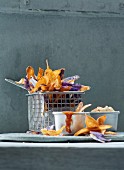 Colourful potato crisps with ketchup and chilli mayonnaise