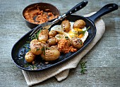 Roast potatoes with a fried egg and tomato dip