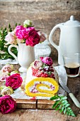 A rose water sponge roll with wild strawberries and whipped cream
