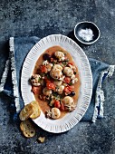 Squid with olives, tomatoes and garlic bread