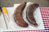 Two Biraldo blood sausages on kitchen board