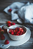 Erdbeeren in Dessertschälchen auf rustikalem Holztisch