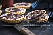 Tartlets filled with sour cherries, vanilla cream and a chocolate glaze (vegan)