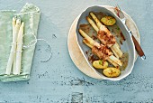 White asparagus wrapped in poultry strips with parsley potatoes