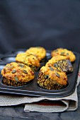 Cheese and herb muffins in a muffin tray