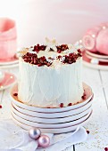 A rolled cake with cranberries and cream for Christmas